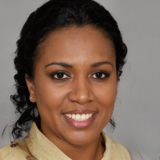 Joyful latino adult female with medium  brown hair and brown eyes