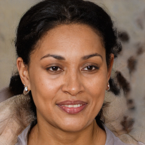 Joyful black adult female with short  brown hair and brown eyes