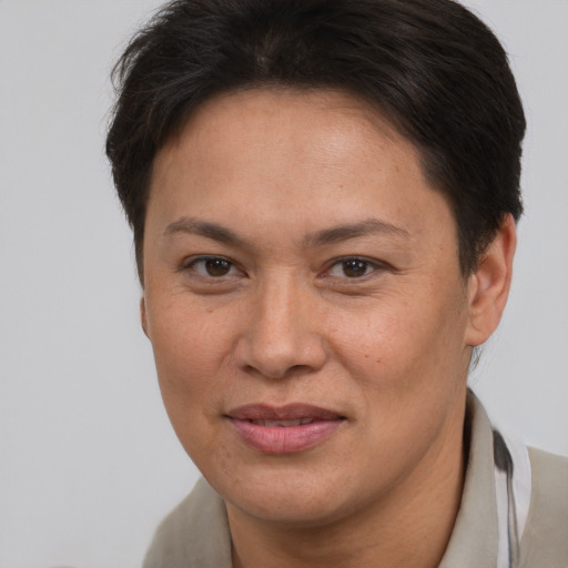Joyful white adult female with short  brown hair and brown eyes