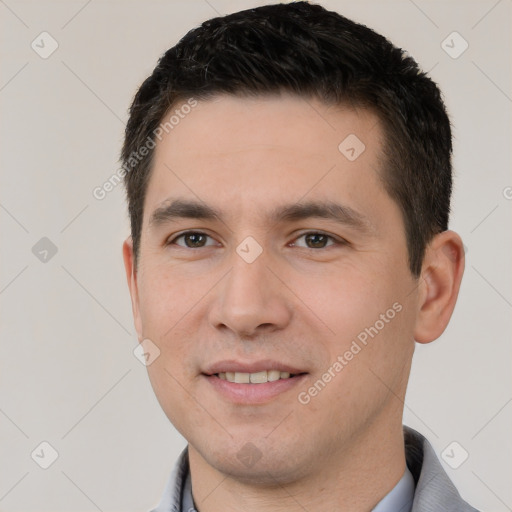 Joyful white young-adult male with short  brown hair and brown eyes