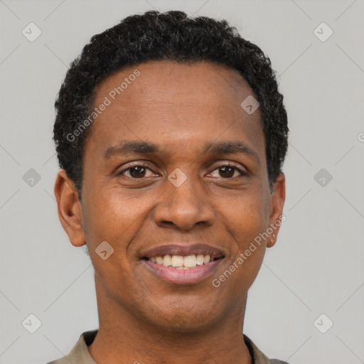 Joyful black young-adult male with short  black hair and brown eyes