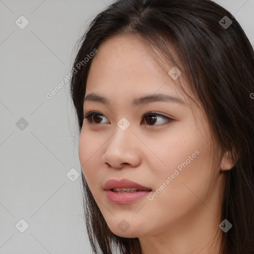 Joyful asian young-adult female with long  brown hair and brown eyes