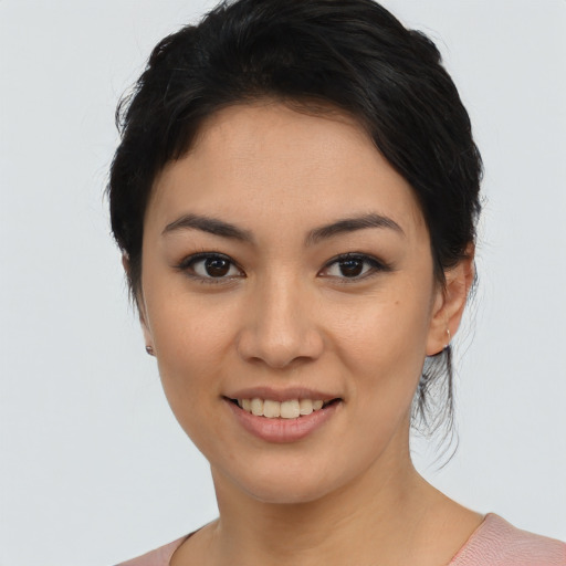 Joyful asian young-adult female with medium  black hair and brown eyes