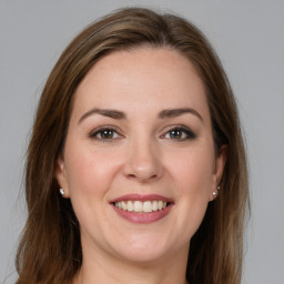 Joyful white young-adult female with long  brown hair and grey eyes