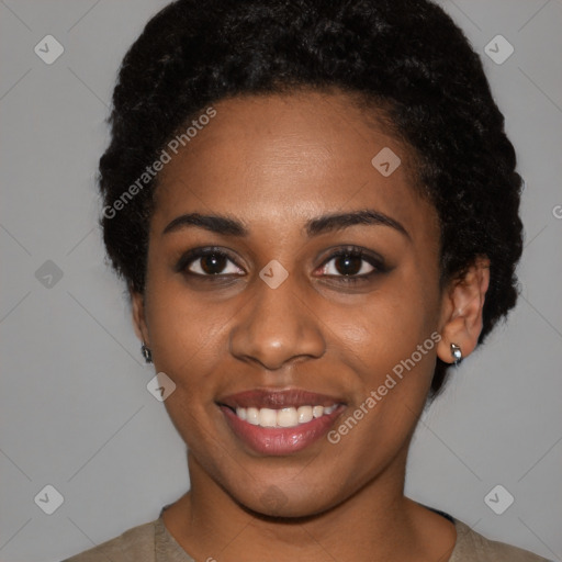 Joyful black young-adult female with short  black hair and brown eyes