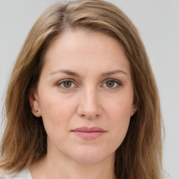 Joyful white young-adult female with long  brown hair and green eyes