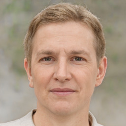 Joyful white adult male with short  brown hair and grey eyes