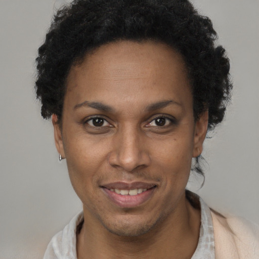 Joyful black adult female with short  brown hair and brown eyes