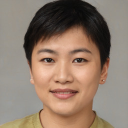 Joyful asian young-adult female with short  brown hair and brown eyes