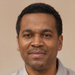 Joyful latino adult male with short  black hair and brown eyes