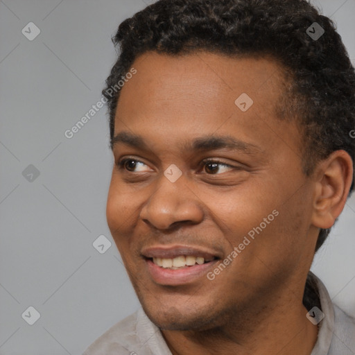 Joyful black young-adult male with short  black hair and brown eyes