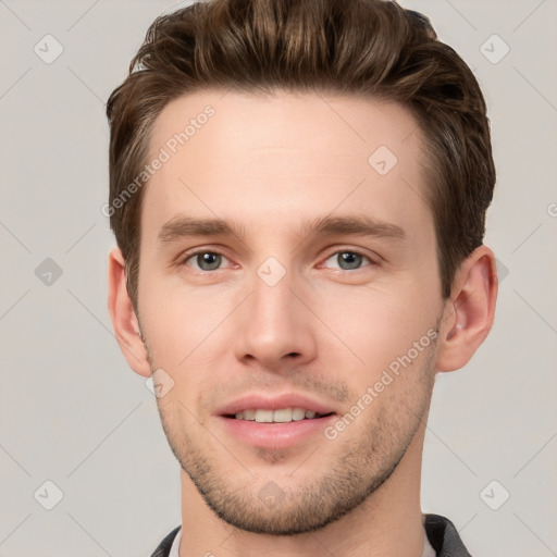 Joyful white young-adult male with short  brown hair and grey eyes