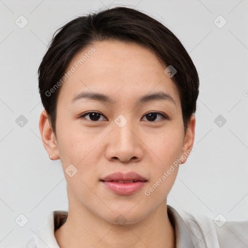 Joyful asian young-adult female with short  brown hair and brown eyes