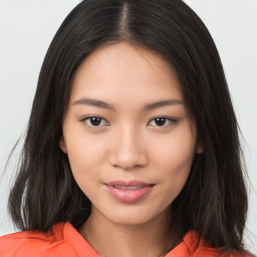 Joyful asian young-adult female with long  brown hair and brown eyes