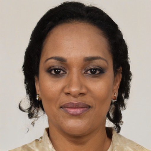 Joyful black adult female with medium  brown hair and brown eyes