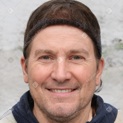 Joyful white adult male with short  brown hair and grey eyes