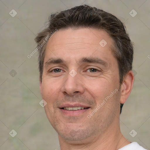 Joyful white adult male with short  brown hair and brown eyes