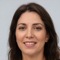 Joyful white adult female with long  brown hair and brown eyes