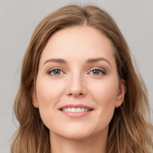 Joyful white young-adult female with long  brown hair and grey eyes