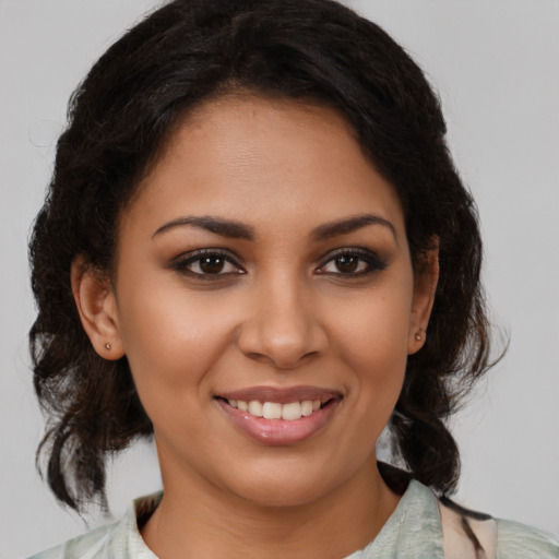 Joyful latino young-adult female with medium  brown hair and brown eyes
