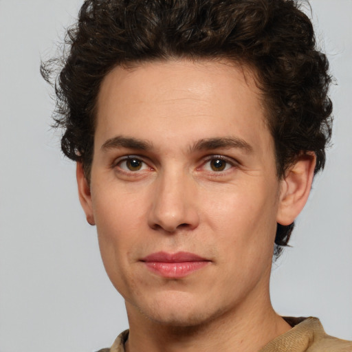 Joyful white young-adult male with short  brown hair and green eyes