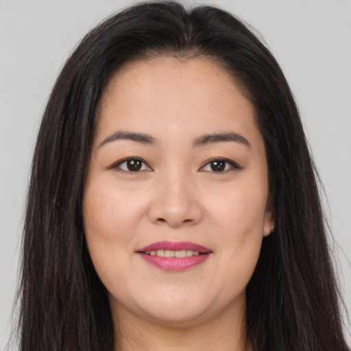 Joyful asian young-adult female with long  brown hair and brown eyes