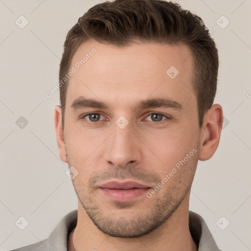 Joyful white young-adult male with short  brown hair and brown eyes