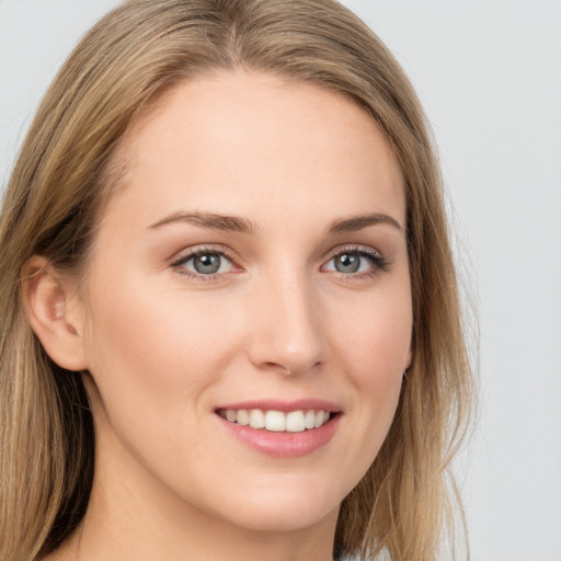 Joyful white young-adult female with long  brown hair and grey eyes