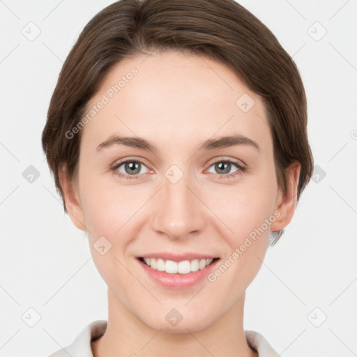 Joyful white young-adult female with short  brown hair and grey eyes