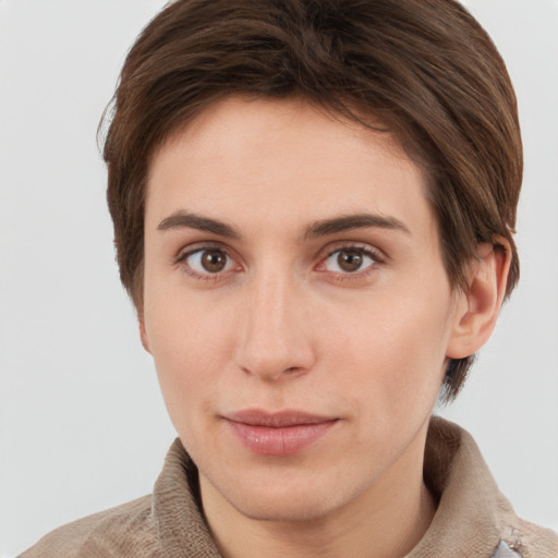 Joyful white young-adult female with short  brown hair and grey eyes