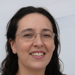 Joyful white adult female with long  brown hair and brown eyes