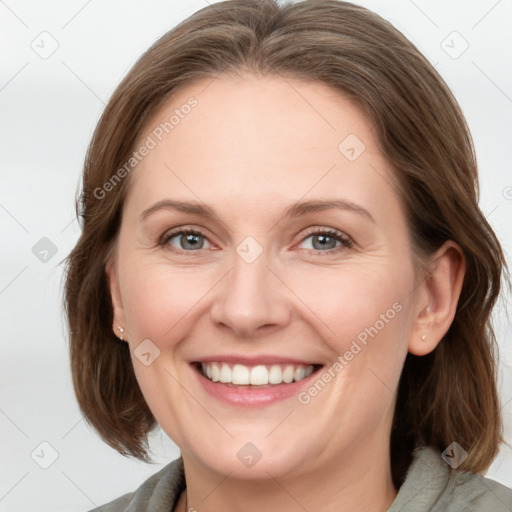 Joyful white adult female with medium  brown hair and grey eyes