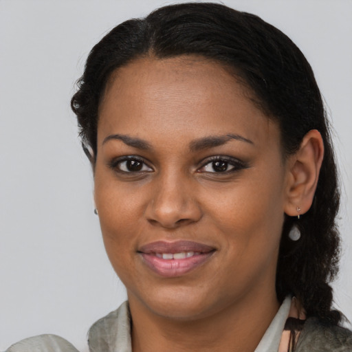 Joyful black young-adult female with medium  brown hair and brown eyes