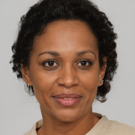 Joyful black adult female with short  brown hair and brown eyes