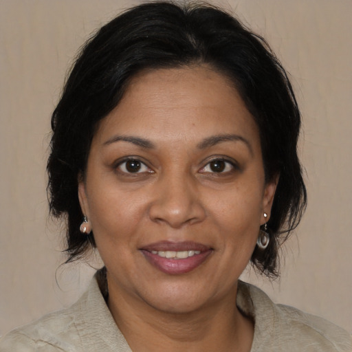 Joyful black adult female with medium  brown hair and brown eyes