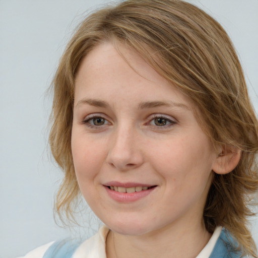 Joyful white young-adult female with medium  brown hair and blue eyes