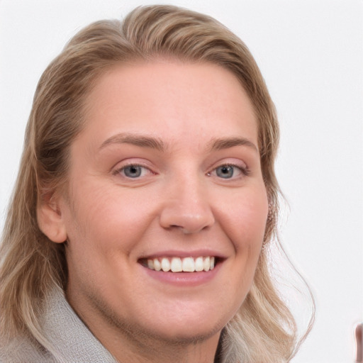 Joyful white young-adult female with long  brown hair and blue eyes