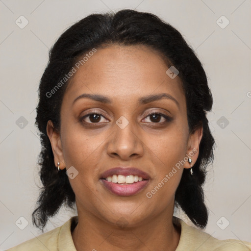 Joyful black adult female with long  brown hair and brown eyes