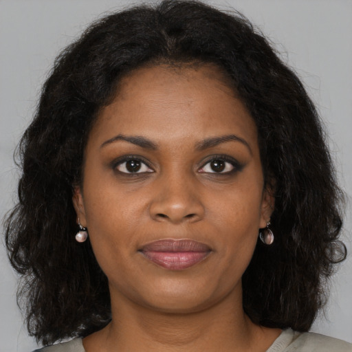 Joyful black young-adult female with medium  brown hair and brown eyes