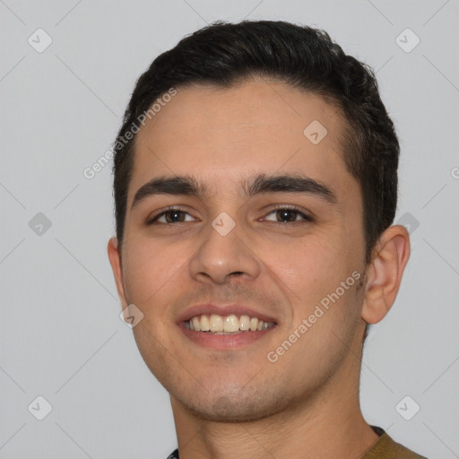 Joyful white young-adult male with short  black hair and brown eyes