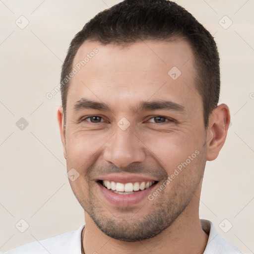 Joyful white young-adult male with short  brown hair and brown eyes