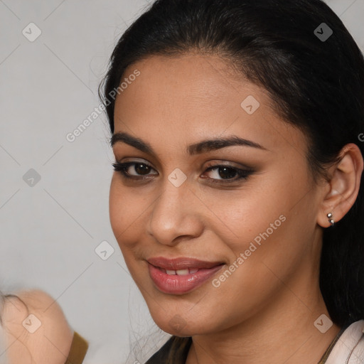 Joyful latino young-adult female with medium  brown hair and brown eyes