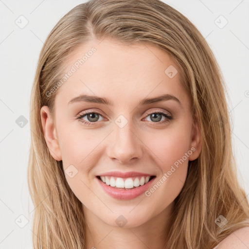 Joyful white young-adult female with long  brown hair and blue eyes