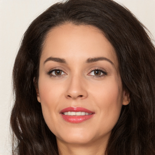 Joyful white young-adult female with long  brown hair and brown eyes