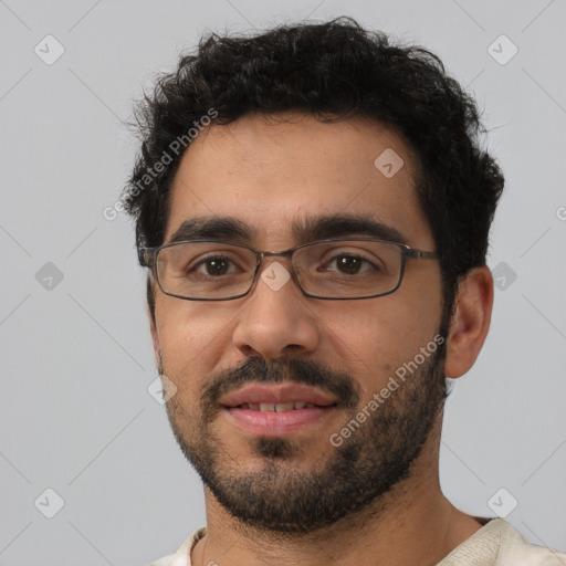 Joyful white young-adult male with short  black hair and brown eyes