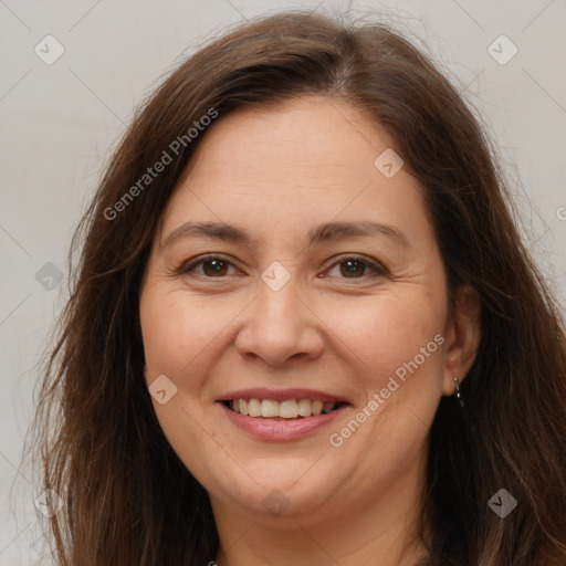 Joyful white adult female with long  brown hair and brown eyes