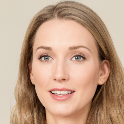 Joyful white young-adult female with long  brown hair and blue eyes