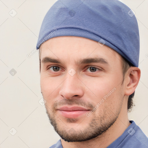 Joyful white young-adult male with short  brown hair and brown eyes