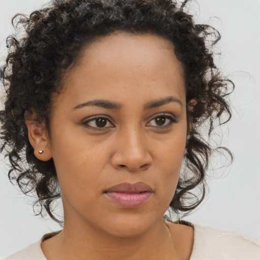 Joyful black young-adult female with medium  brown hair and brown eyes