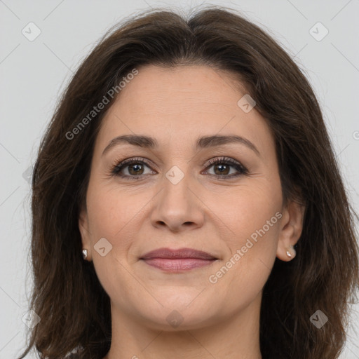 Joyful white adult female with long  brown hair and brown eyes